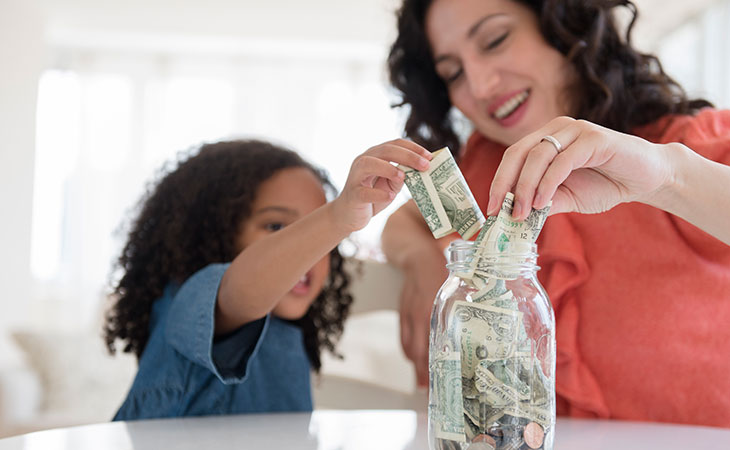 Mother and daughter saving money