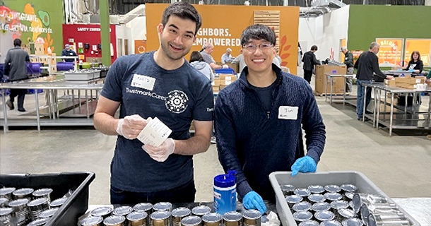 Employees volunteering packing canned goods.